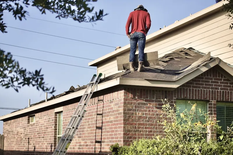 Professional roofer working on a residential roof in Pigeon Cove
